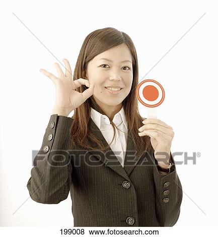 A Japanese woman making an 'ok' sign View Large Photo Image Stock Photo - A Japanese woman making an 'ok' sign. Fotosearch