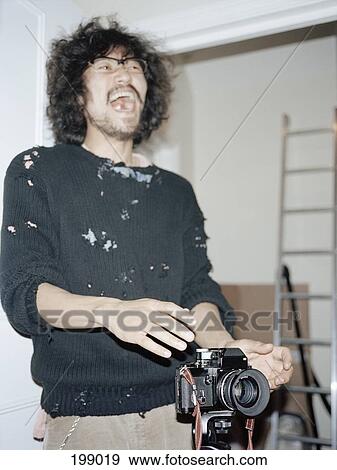 A photographer laughing in a studio View Large Photo Image Stock Photo - A photographer laughing in a studio. Fotosearch