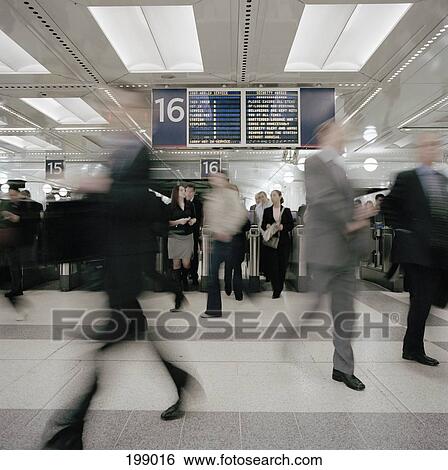 Commuters in a train station View Large Photo Image Stock Photograph - Commuters in a train station. Fotosearch