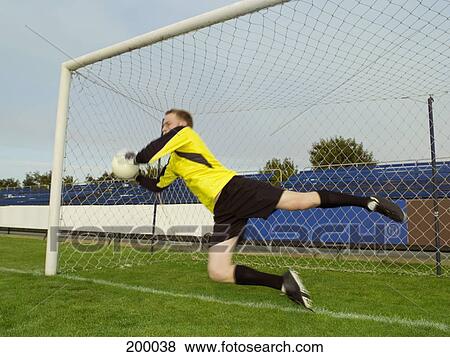 A soccer goalkeeper jumping to block the ball View Large Photo Image Stock Photo - A soccer goalkeeper jumping to block the ball. Fotosearch