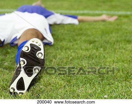A soccer player lying down View Large Photo Image Stock Image - A soccer player lying down. Fotosearch