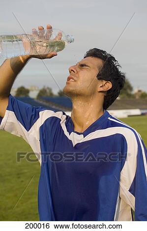 A soccer player pouring water over his face View Large Photo Image Stock Photograph - A soccer player pouring water over his face. Fotosearch