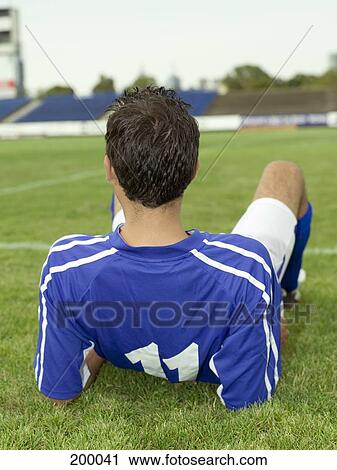 A soccer player resting on the sidelines View Large Photo Image Stock Image - A soccer player resting on the sidelines. Fotosearch