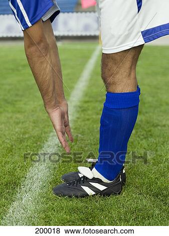 A soccer player stretching on the sidelines View Large Photo Image Stock Photo - A soccer player stretching on the sidelines. Fotosearch