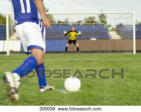 A soccer player taking a penalty shot on goal View Large Photo Image Stock Photo - A soccer player taking a penalty shot on goal. Fotosearch