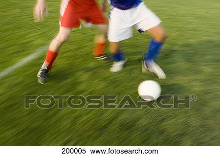 Two people playing soccer View Large Photo Image Stock Photography - Two people playing soccer. Fotosearch