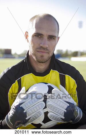 A goalkeeper holding a soccer ball View Large Photo Image Stock Image - A goalkeeper holding a soccer ball. Fotosearch