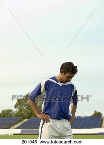 A portrait of a soccer player looking down View Large Photo Image Stock Photograph - A portrait of a soccer player looking down. Fotosearch