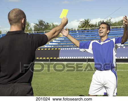 A referee giving a soccer player a yellow card View Large Photo Image Picture - A referee giving a soccer player a yellow card. Fotosearch