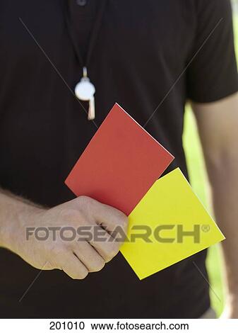 A referee holding red and yellow cards View Large Photo Image Stock Image - A referee holding red and yellow cards. Fotosearch