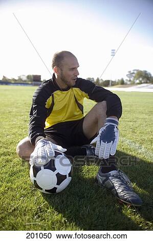 Stock Image - A soccer goalkeeper holding a soccer ball. Fotosearch