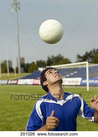 A soccer player hitting a ball with his head View Large Photo Image Stock Photograph - A soccer player hitting a ball with his head. Fotosearch