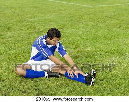 A soccer player stretching on a soccer field View Large Photo Image Stock Photography - A soccer player stretching on a soccer field. Fotosearch