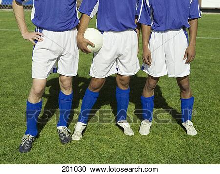Three soccer players in a line View Large Photo Image Stock Image - Three soccer players in a line. Fotosearch