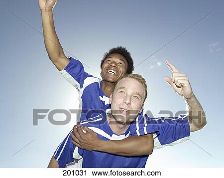 Two soccer players celebrating a victory View Large Photo Image Stock Image - Two soccer players celebrating a victory. Fotosearch