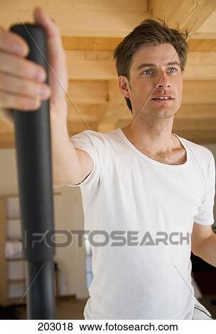 Man working out on exercise equipment View Large Photo Image Stock Photo - Man working out on exercise equipment. Fotosearch