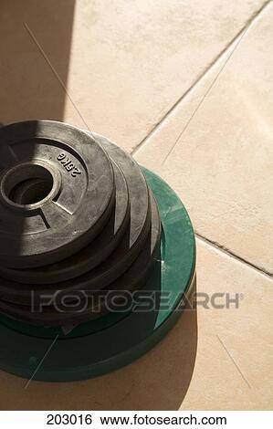 Stack of weights on floor View Large Photo Image Stock Photograph - Stack of weights on floor. Fotosearch