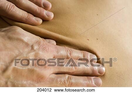 Close-up of person receiving back massage View Large Photo Image Stock Image - Close-up of person receiving back massage. Fotosearch