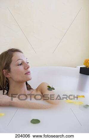 Young woman sitting in bathtub View Large Photo Image Stock Photograph - Young woman sitting in bathtub. Fotosearch