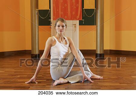 Young woman stretching on floor View Large Photo Image Stock Photography - Young woman stretching on floor. Fotosearch