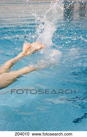 Young woman swimming in pool View Large Photo Image Stock Image - Young woman swimming in pool. Fotosearch