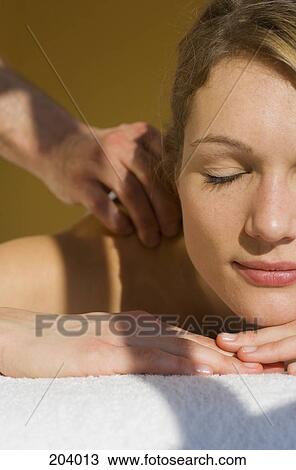 Young woman with eyes closed receiving massage View Large Photo Image Stock Image - Young woman with eyes closed receiving massage. Fotosearch