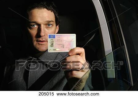 Stock Photography - Male driver holding his ID card. Fotosearch