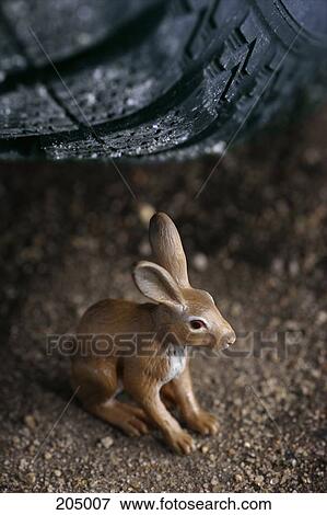 Rabbit figurine under car tire View Large Photo Image Stock Photo - Rabbit figurine under car tire. Fotosearch