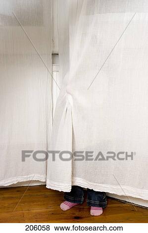A child hiding behind a curtain View Large Photo Image Stock Photo - A child hiding behind a curtain. Fotosearch