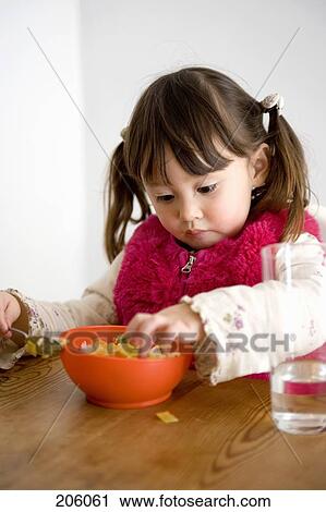 A little girl eating View Large Photo Image Stock Image - A little girl eating. Fotosearch
