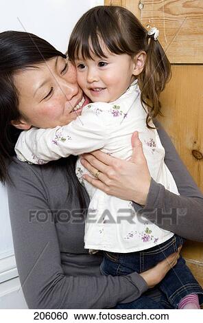 A mother hugging her daughter View Large Photo Image Stock Image - A mother hugging her daughter. Fotosearch
