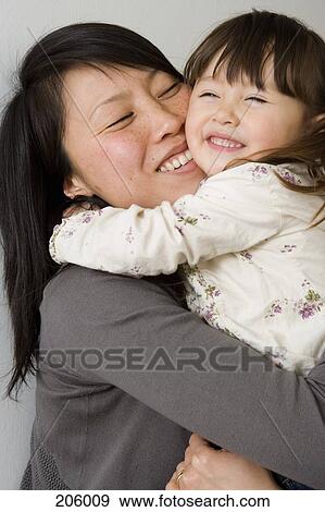 Stock Photo - Mother holding daughter. Fotosearch