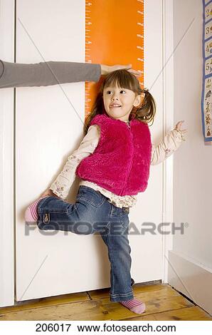 Young girl being measured on height chart View Large Photo Image Stock Photo - Young girl being measured on height chart. Fotosearch