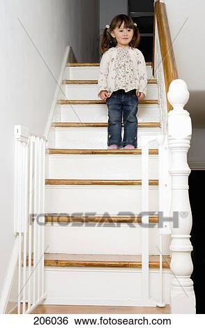 Young girl standing on a staircase View Large Photo Image Stock Photograph - Young girl standing on a staircase. Fotosearch