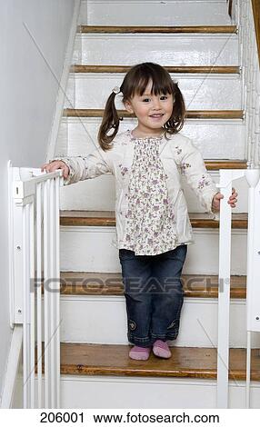 Young girl standing on steps and smiling View Large Photo Image Stock Image - Young girl standing on steps and smiling. Fotosearch