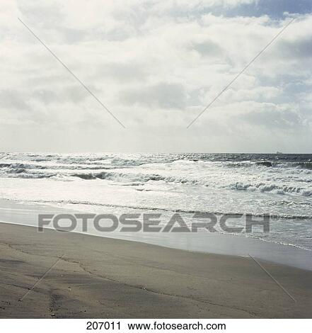 Deserted beach on overcast day View Large Photo Image Stock Image - Deserted beach on overcast day. Fotosearch