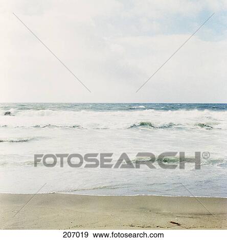 View of the ocean from the beach on overcast day View Large Photo Image Stock Photo - View of the ocean from the beach on overcast day. Fotosearch