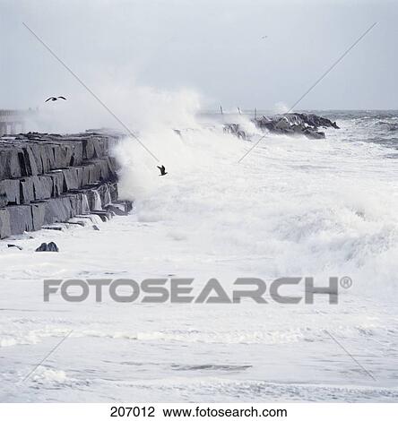 Wave breaking on stone embankment View Large Photo Image Stock Image - Wave breaking on stone embankment. Fotosearch