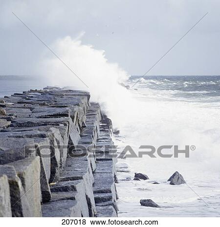 Wave breaking on stone embankment View Large Photo Image Stock Photo - Wave breaking on stone embankment. Fotosearch