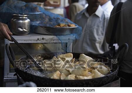 Market vendor cooking samosa View Large Photo Image Stock Image - Market vendor cooking samosa. Fotosearch