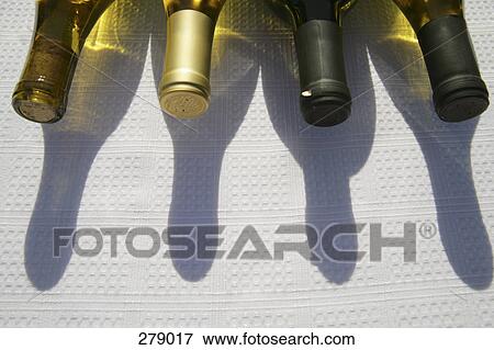 Bottles of wine on table View Large Photo Image Stock Photo - Bottles of wine on table. Fotosearch