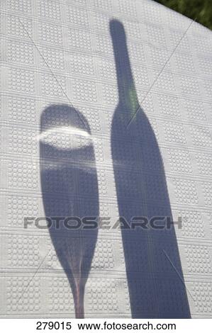 Stock Photography - Shadow of wine glass next to wine bottle. Fotosearch