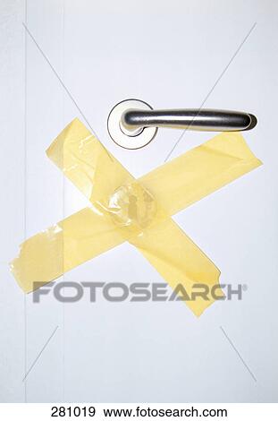 Stock Photo - Door with lock covered by adhesive tape. Fotosearch