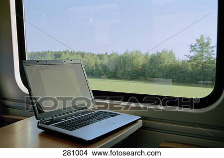 Laptop on table in passenger train View Large Photo Image Picture - Laptop on table in passenger train. Fotosearch