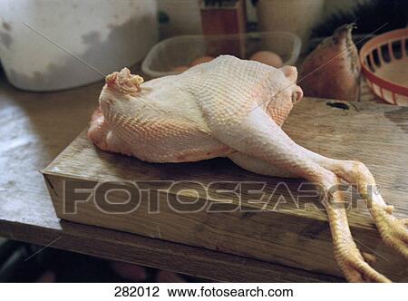 Whole chicken on wooden cutting board View Large Photo Image Stock Image - Whole chicken on wooden cutting board. Fotosearch