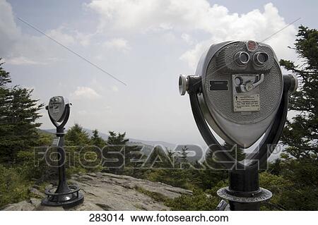 Coin-operated binoculars overlooking mountains View Large Photo Image Picture - Coin-operated binoculars overlooking mountains. Fotosearch