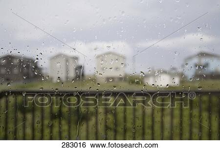 Raindrops on window View Large Photo Image Stock Photograph - Raindrops on window. Fotosearch