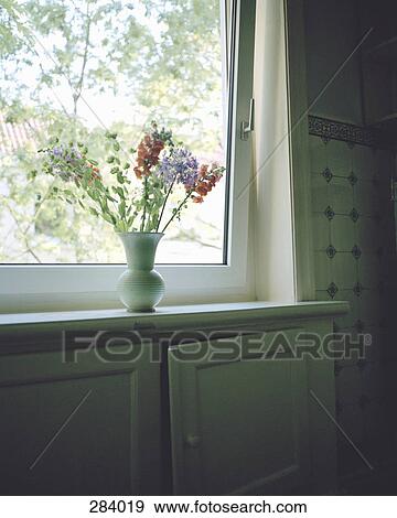 Flowers in vase on window sill View Large Photo Image Stock Photo - Flowers in vase on window sill. Fotosearch