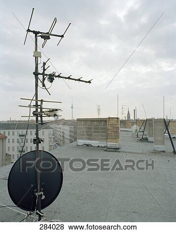 TV aerial and satellite dish on apartment roof View Large Photo Image Stock Photo - TV aerial and satellite dish on apartment roof. Fotosearch