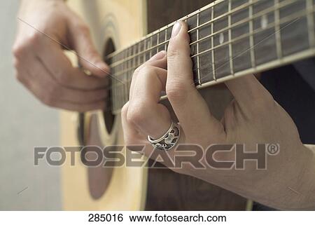 Stock Photograph - Man playing acoustic guitar. Fotosearch